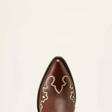 Brown cowboy boot with decorative white patterns on a beige background